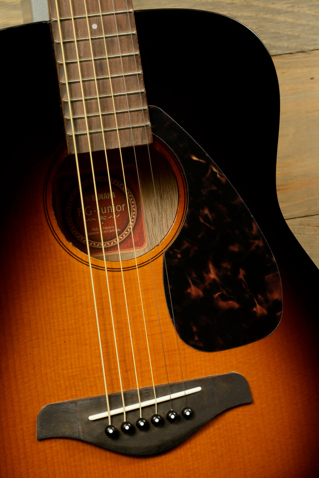 Yamaha acoustic guitar, sunburst finish, close-up view of the body and strings