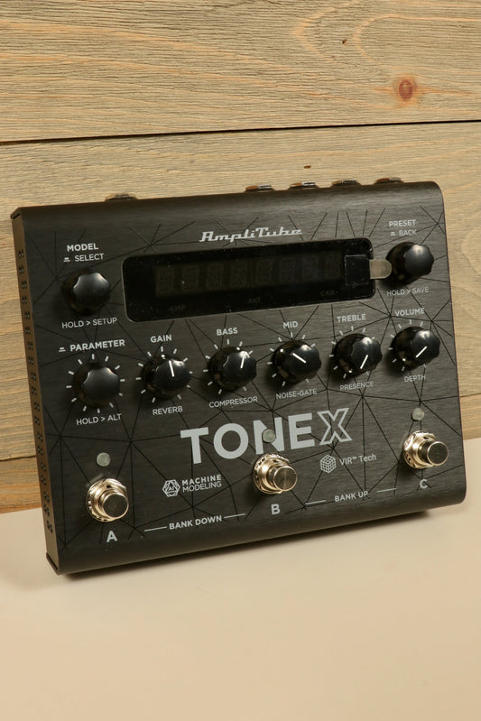 IK Multimedia Tonex pedal for guitar with multiple control knobs for gain bass mid treble and volume