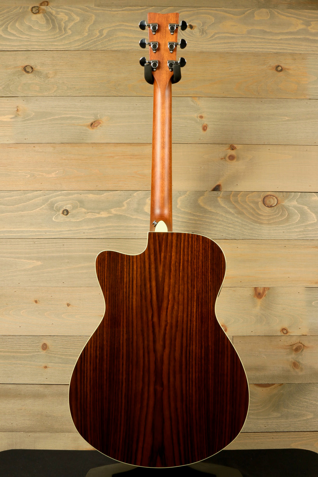 Yamaha acoustic electric guitar, natural wood finish, back view showcasing the rich grain