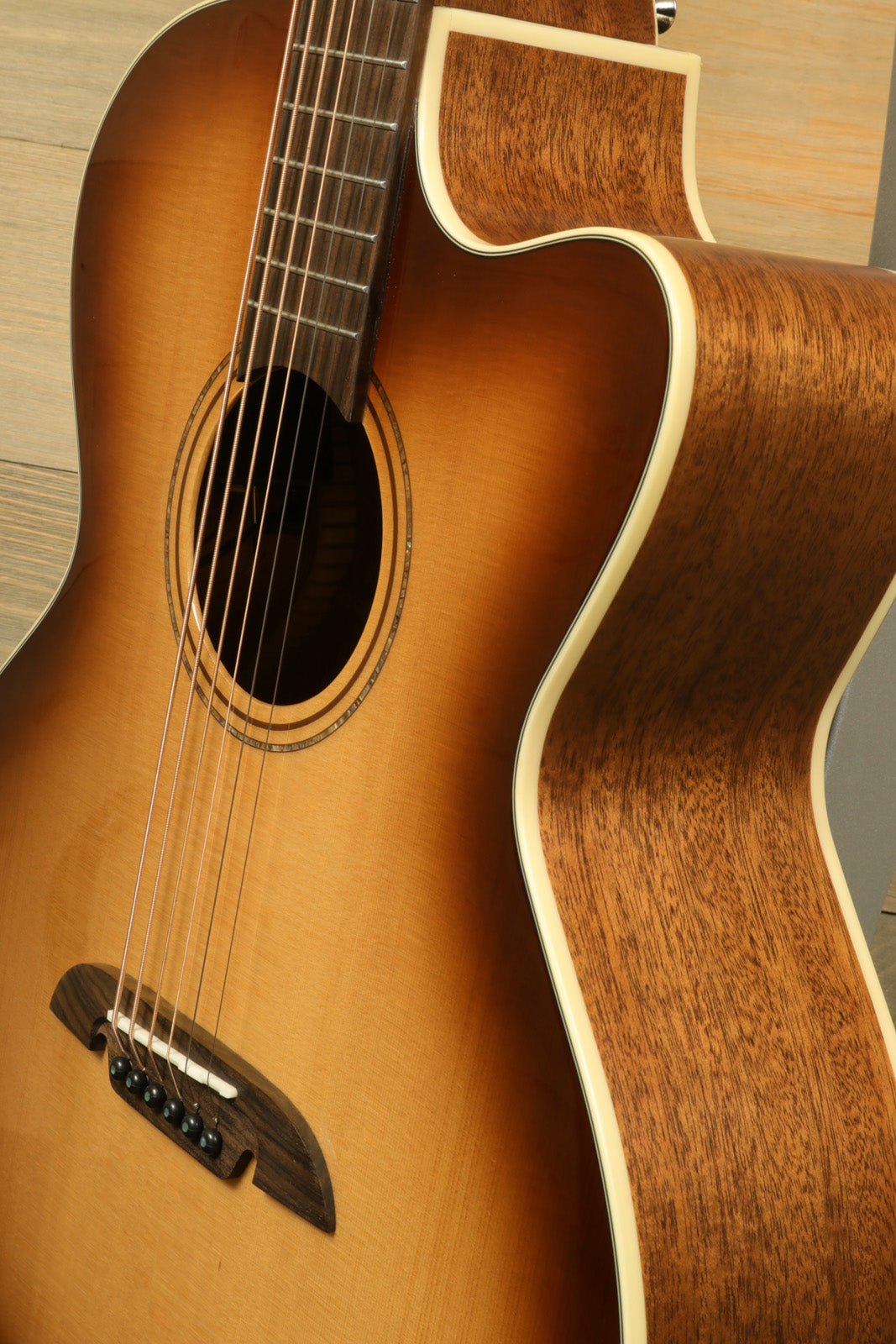 Alvarez Baritone Acoustic Electric Guitar with a natural wood finish, side view showcasing its craftsmanship
