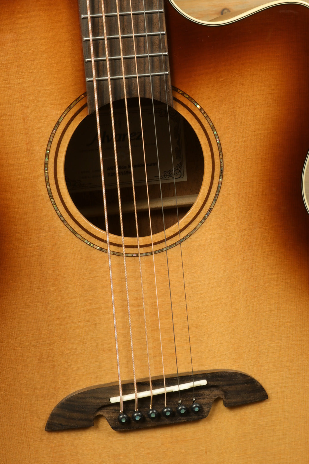 Alvarez Baritone Acoustic Electric Guitar with natural wood finish, close-up front view showing strings and soundhole