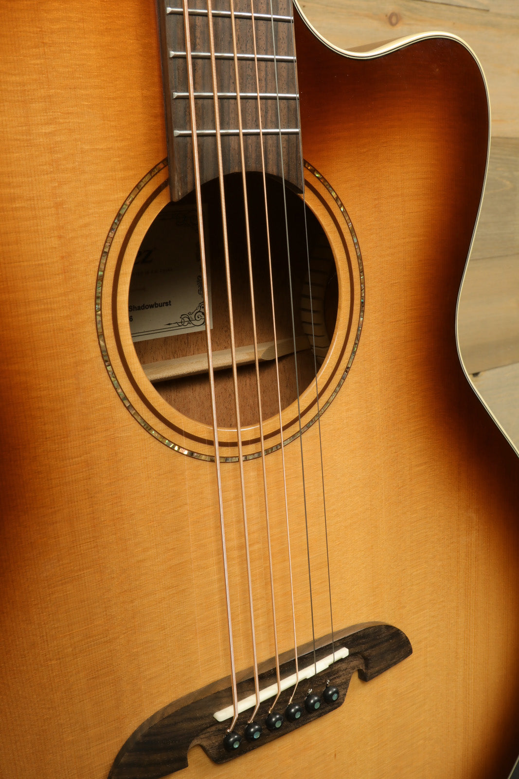 Alvarez Baritone Acoustic Electric Guitar with natural wood finish, close-up view of body and strings