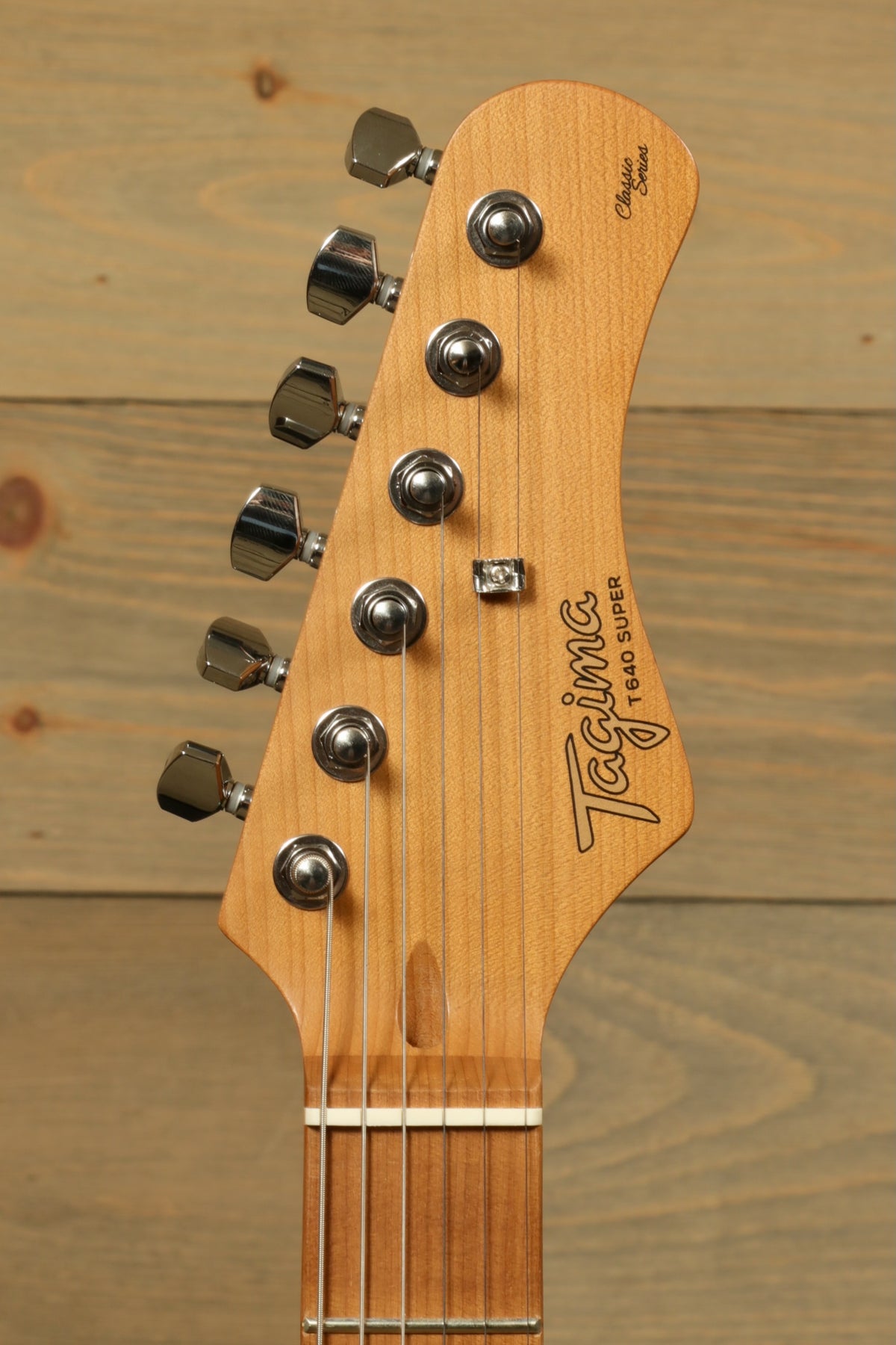 Tagima electric guitar guitars headstock view, featuring vintage style tuners and natural wood finish