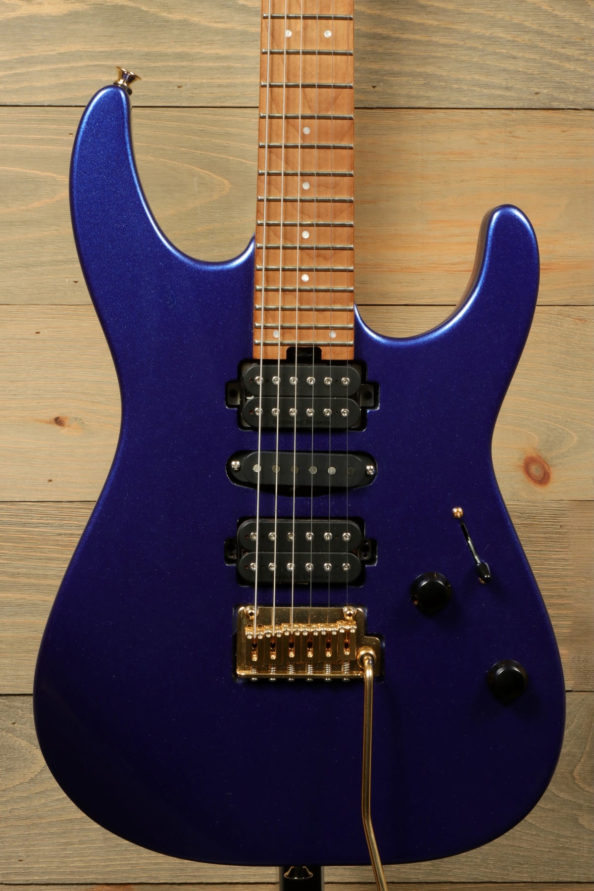 Charvel Pro-Mod DK24 HSH electric guitar in blue, top view with gold hardware and black pickups