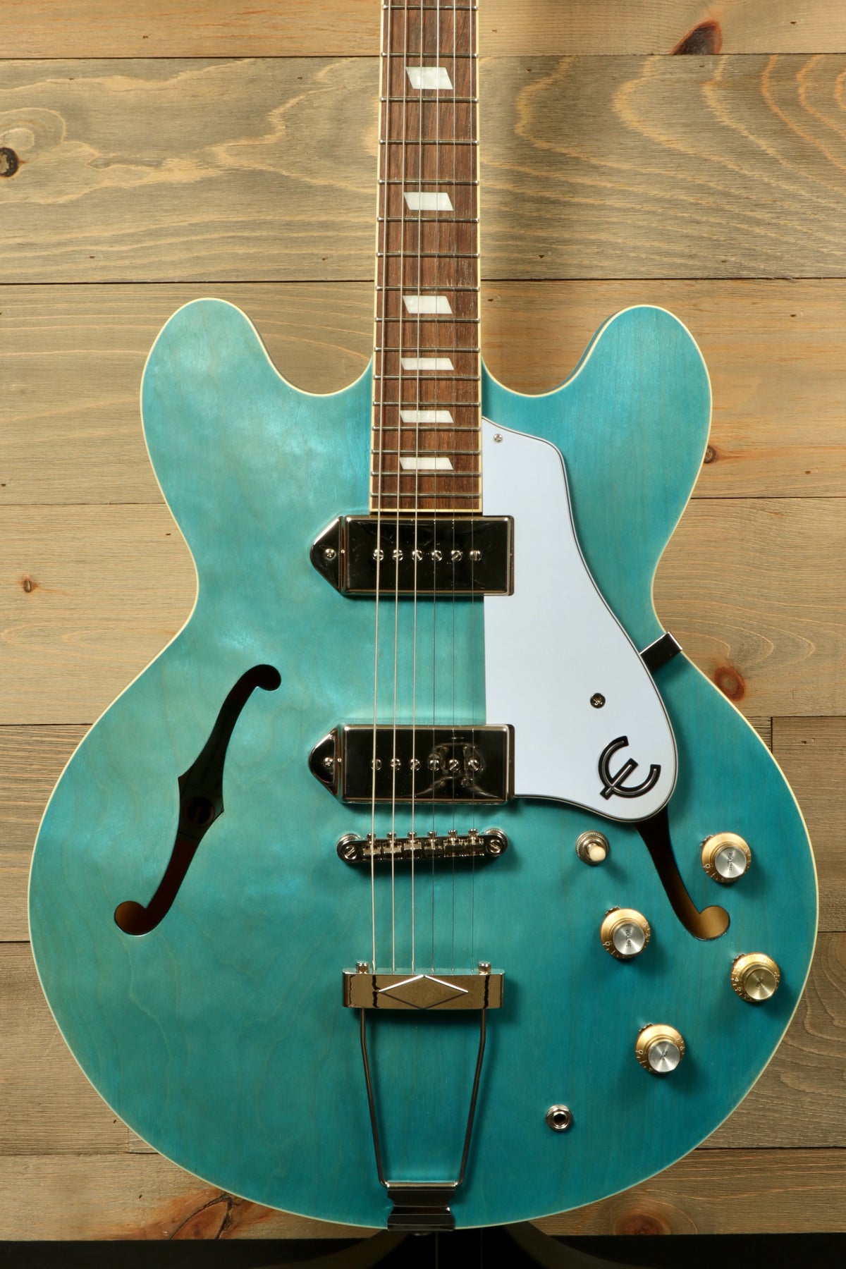 Epiphone Casino Worn in turquoise, front view showcasing the hollow body and vintage style pickups