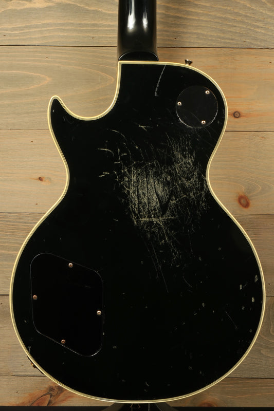 Greco guitar, black finish, back view showcasing scratches and wear on body