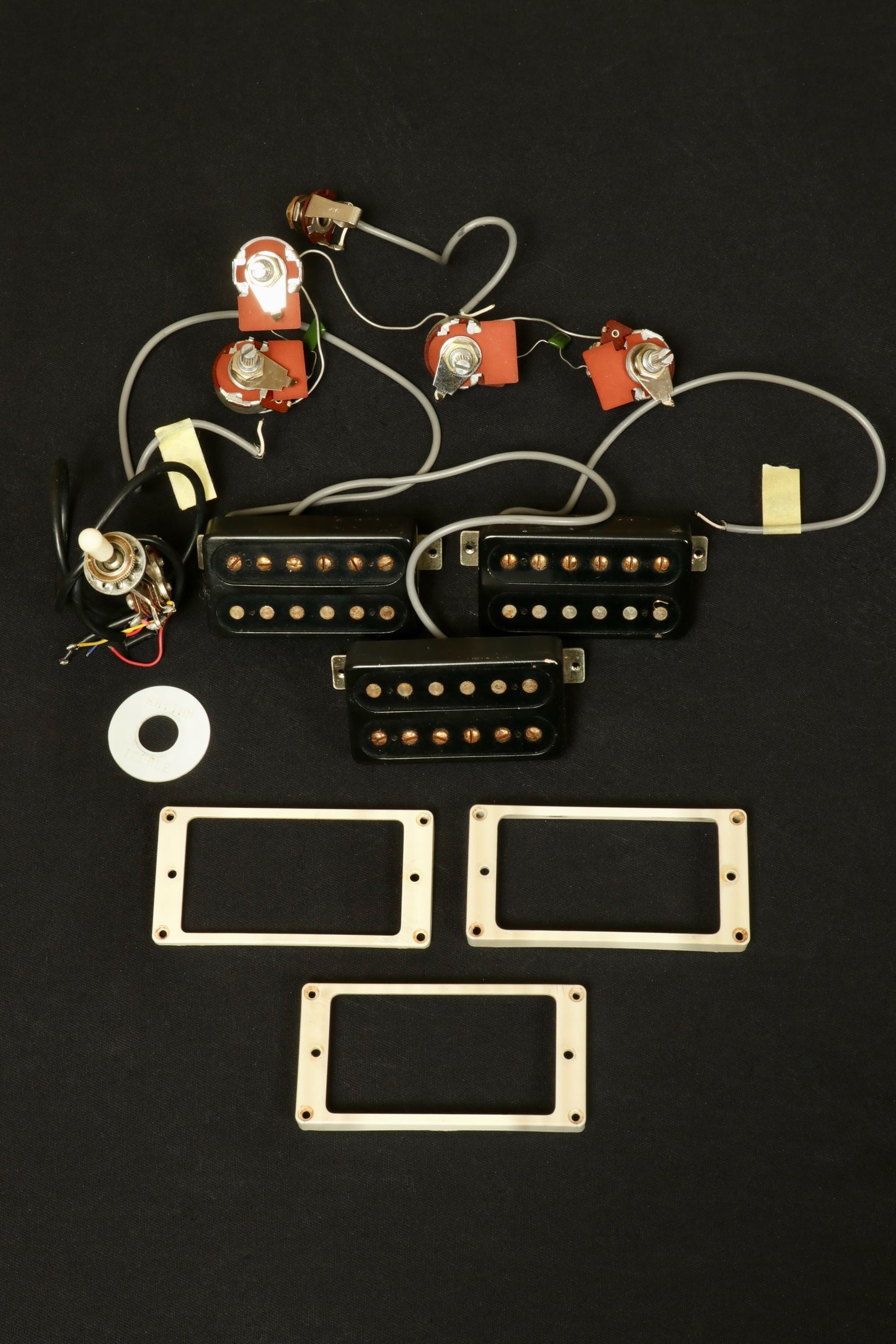 Greco guitar electric guitar parts including pickups and control knobs, overhead view