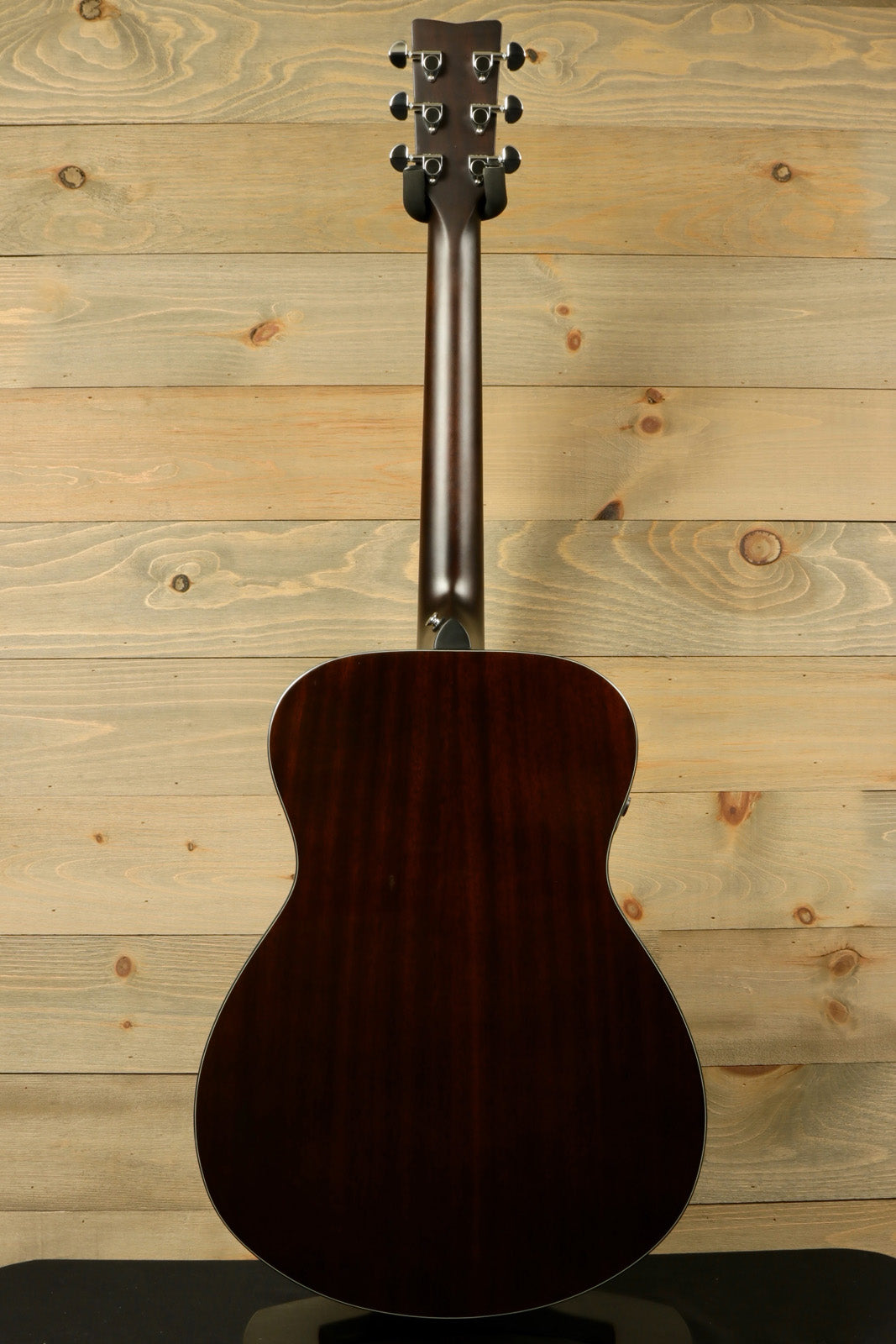 Yamaha acoustic electric guitar, dark wood finish, back view showcasing smooth contours
