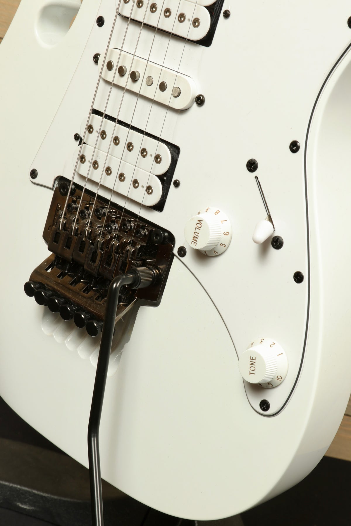 Ibanez JEMJR Steve Vai white electric guitar, close-up of pickups and controls