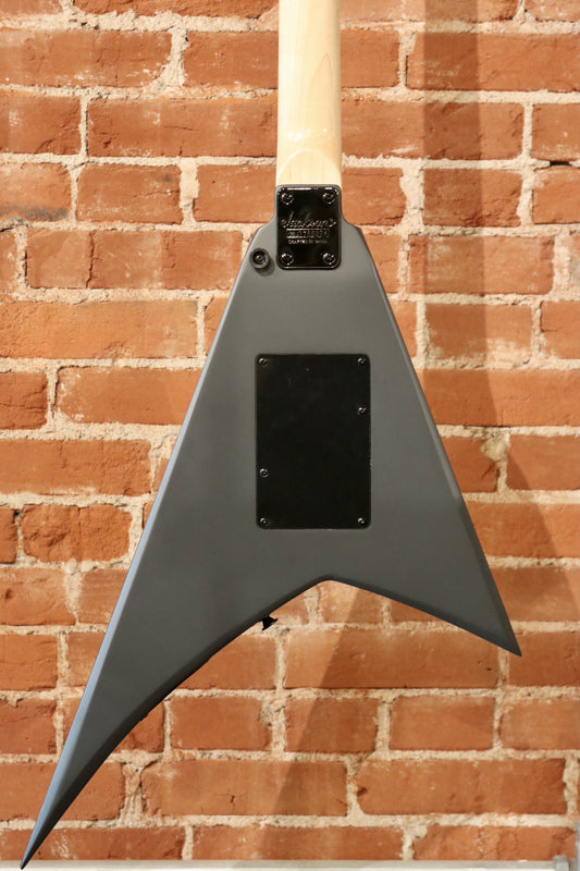 Jackson left handed guitar in sleek gray finish, back view showcasing distinctive body shape