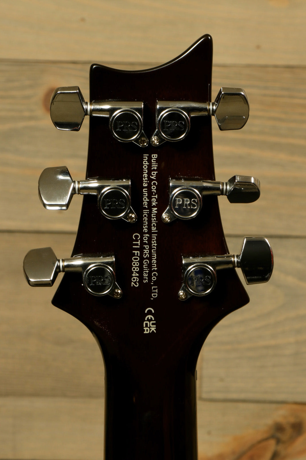 Back of PRS Paul Reed Smith SE DGT Sunburst with PRS Gig Bag showcasing tuning pegs and logo