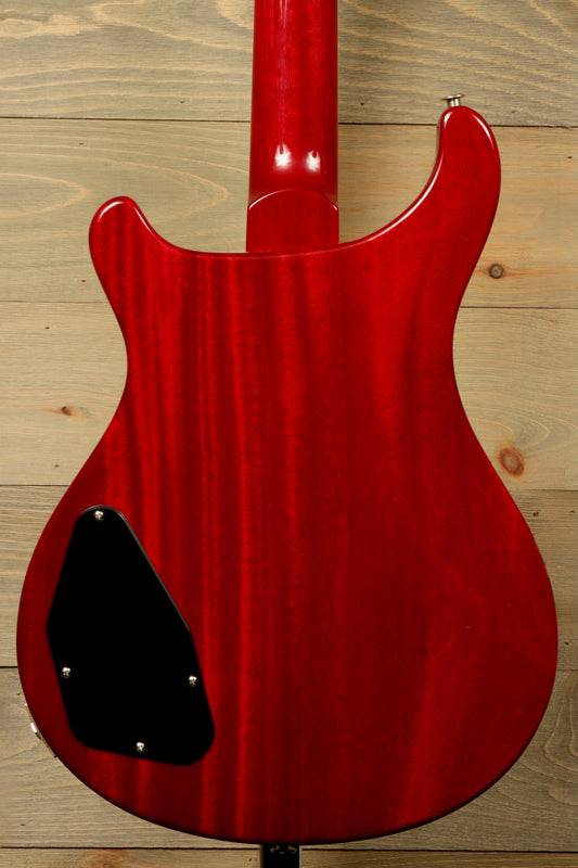 Close-up of PRS 594 McCarty electric guitar body in a striking red finish with a smooth texture