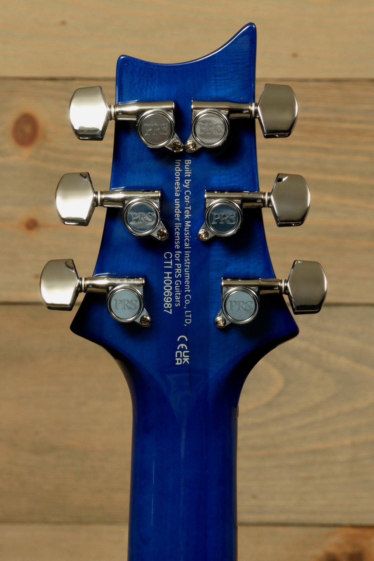 PRS SE Special Semi-Hollow electric guitar, blue finish, back view of the headstock with tuners