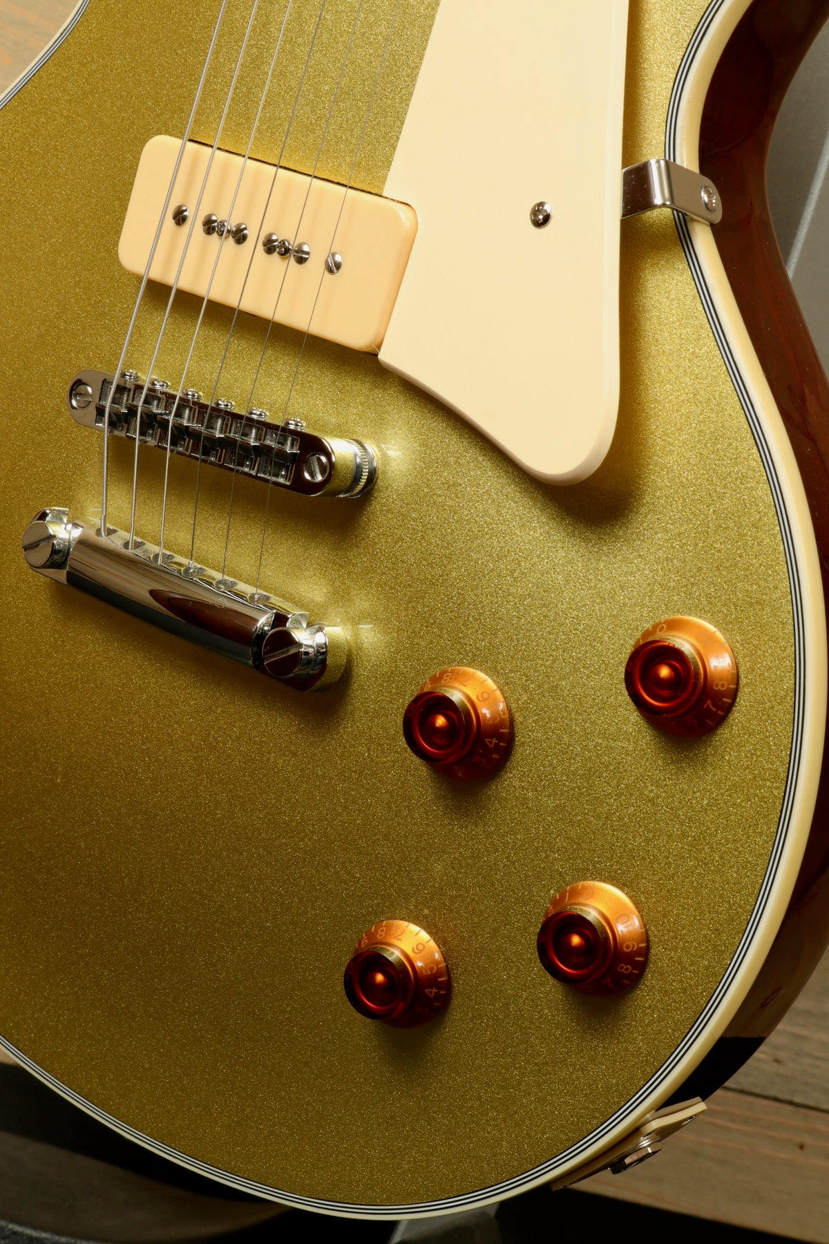 Sire Electric Guitar Goldtop with a stunning gold finish and versatile control knobs, close-up view