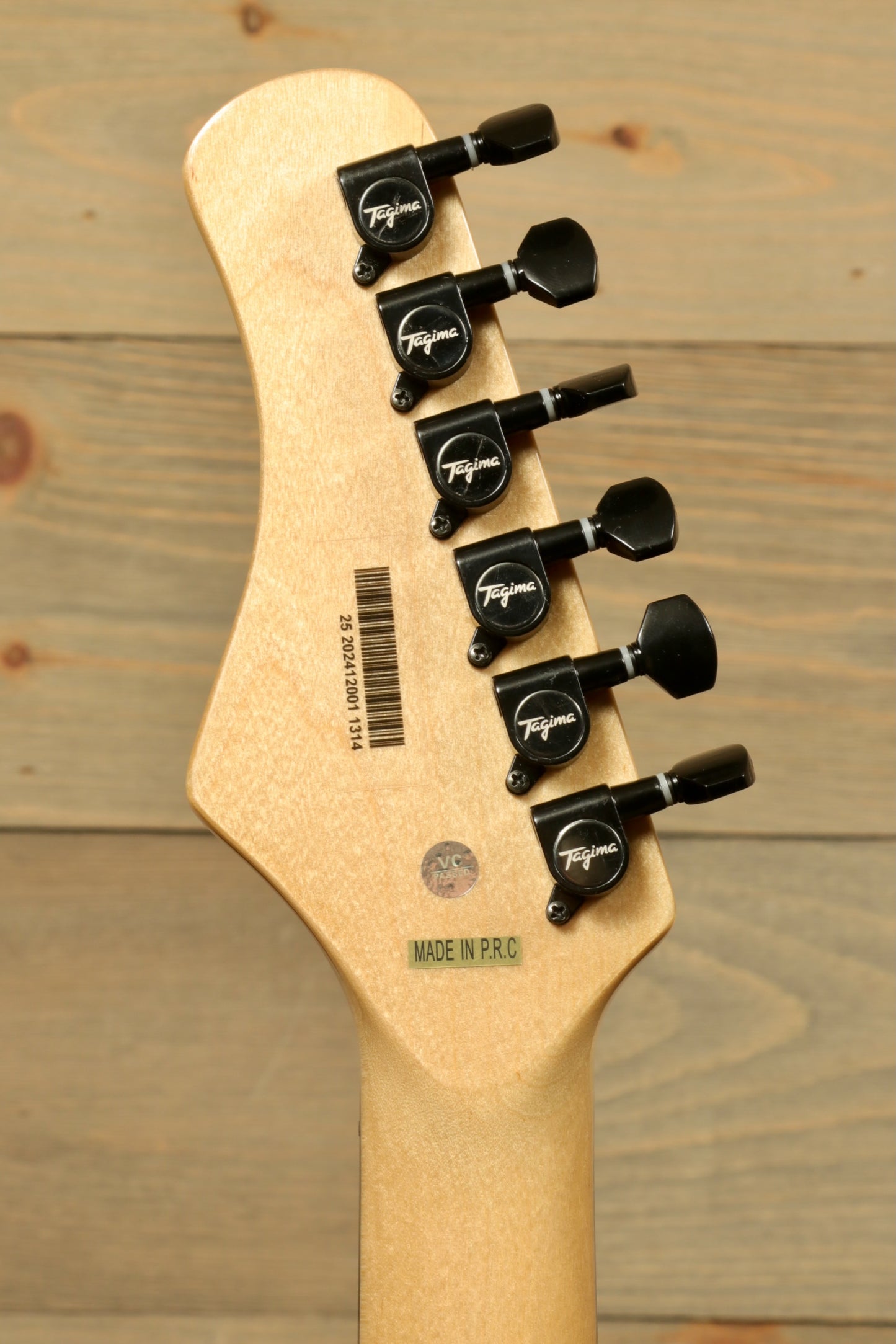 Back view of Tagima Sixmart electric guitar showcasing tuning pegs and smooth wood finish