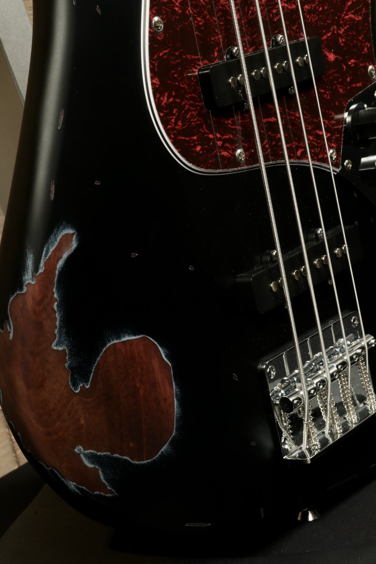 Tagima TBA-73 Electric Bass in black with unique wood finish, close-up view showing body details