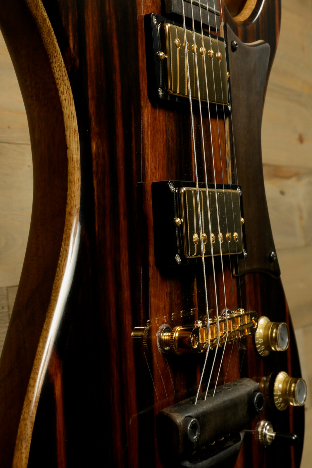 Close-up of a Weller Marquee PROTOTYPE guitar featuring gold hardware and detailed wood grain