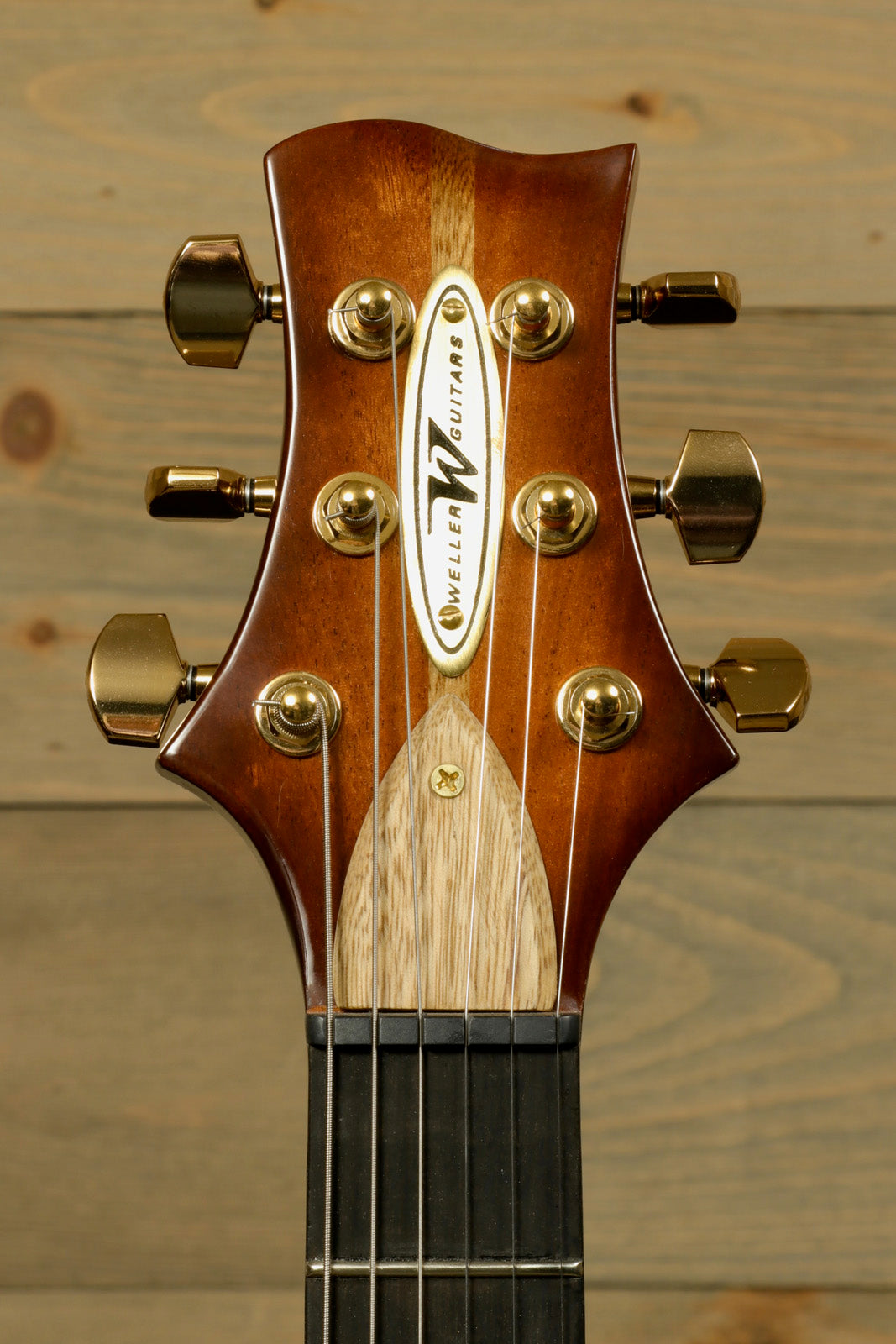 Close-up of Weller Marquee PROTOTYPE guitar headstock with elegant design and gold tuning pegs