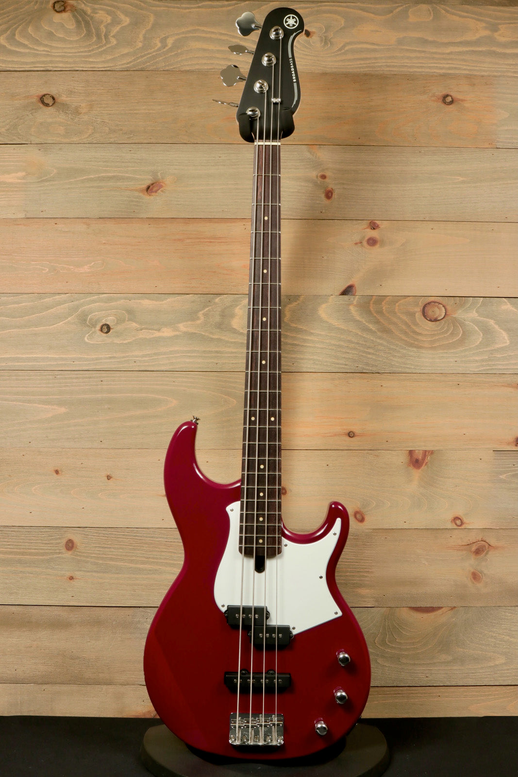 Yamaha BB234 4-String Electric Bass Guitar Raspberry Red, front view on wooden background