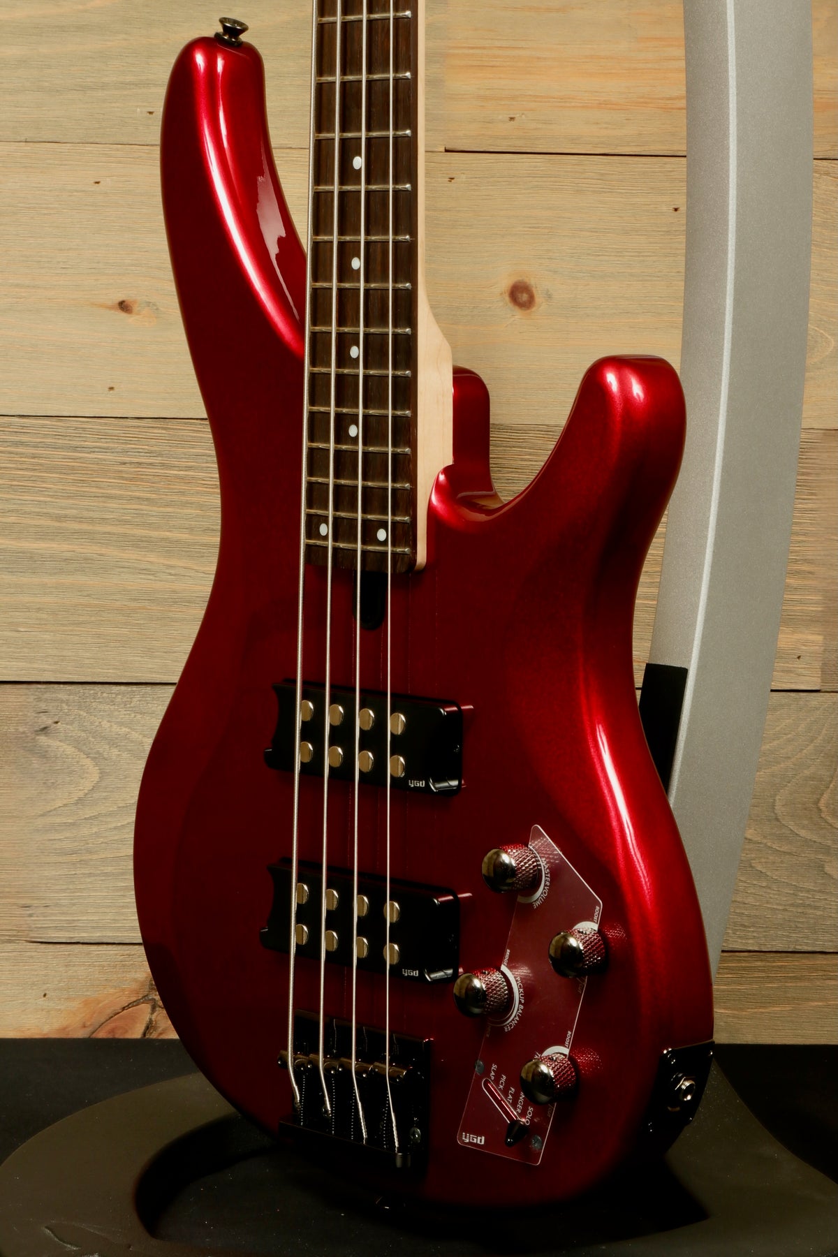 Yamaha electric bass and guitar in glossy red finish, front view showcasing body and controls