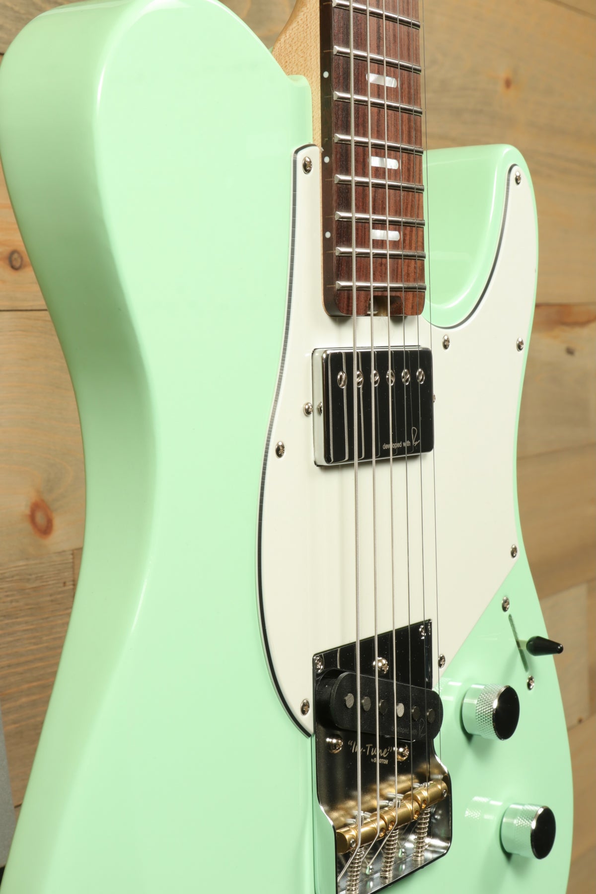 Yamaha Pacifica Peppermint Green, side view with double cutaway and humbucker pickups