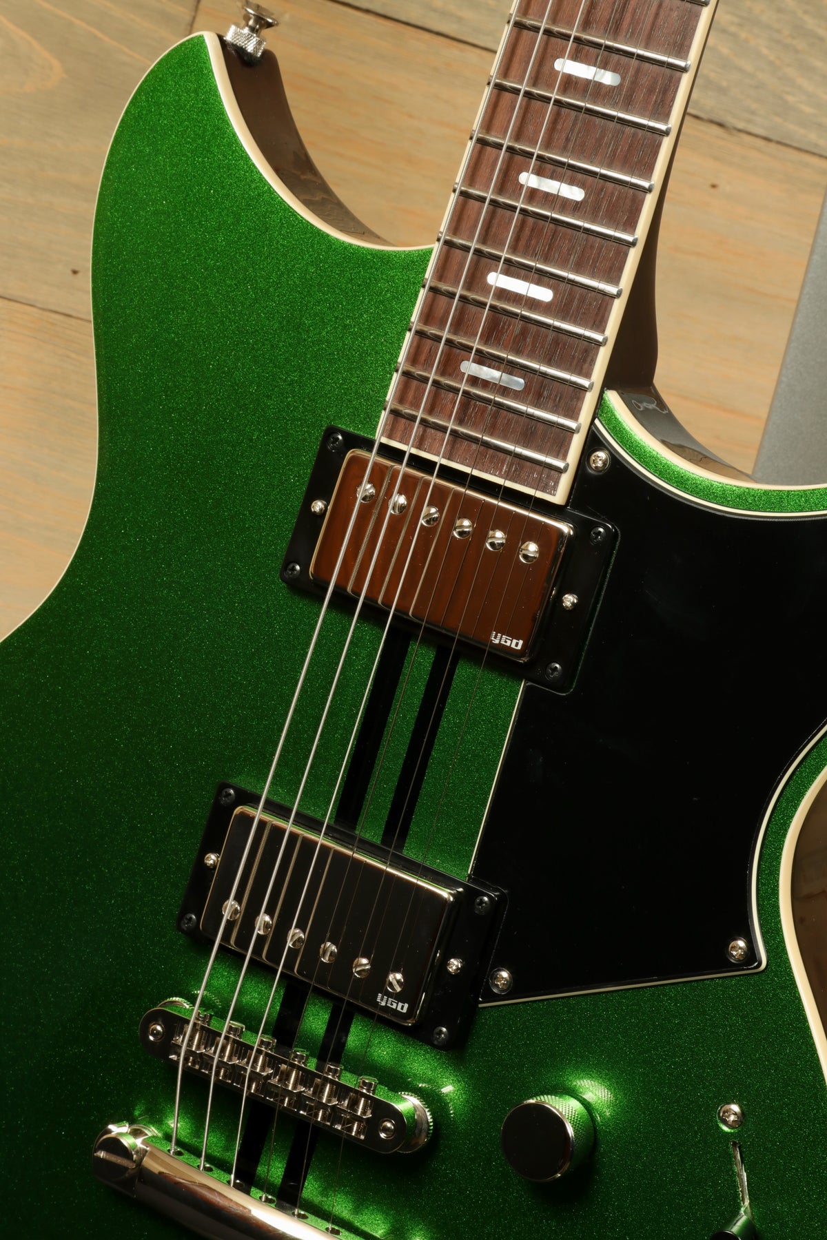 Yamaha Revstar Standard RSS20 electric guitar in metallic green, close-up view of the body and neck