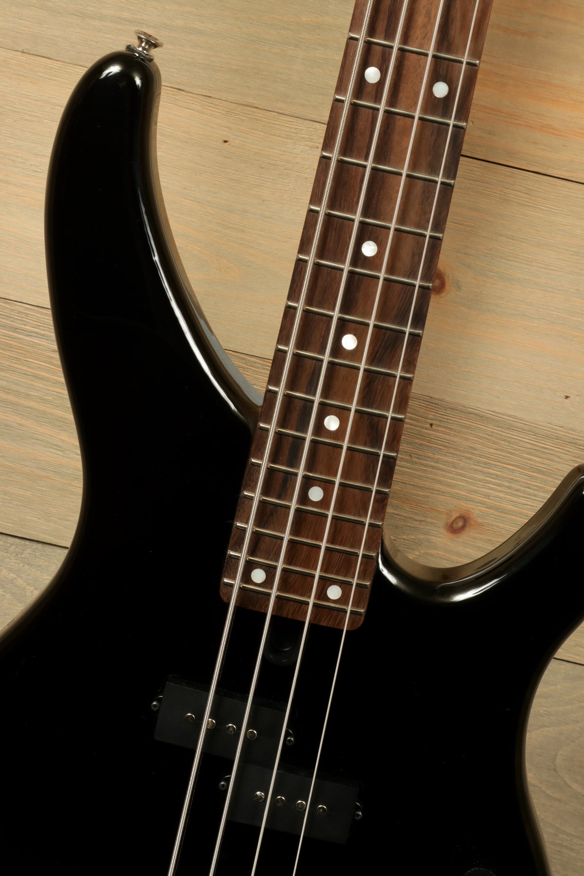 Yamaha TRBX174 black bass guitar, close-up of fingerboard and neck details