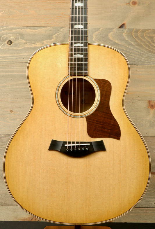 a small acoustic guitar sitting on top of a stand