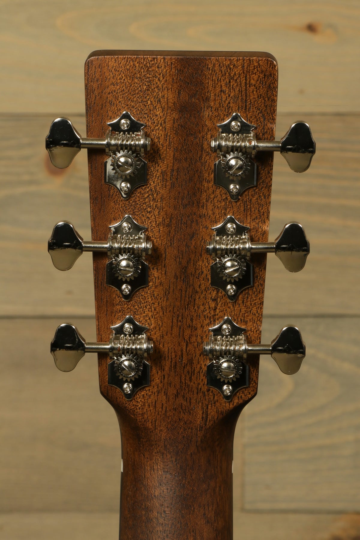 Back view of the headstock of the Eastman E3OME acoustic guitar, highlighting the vintage-style tuning machines and beautiful wood finish.