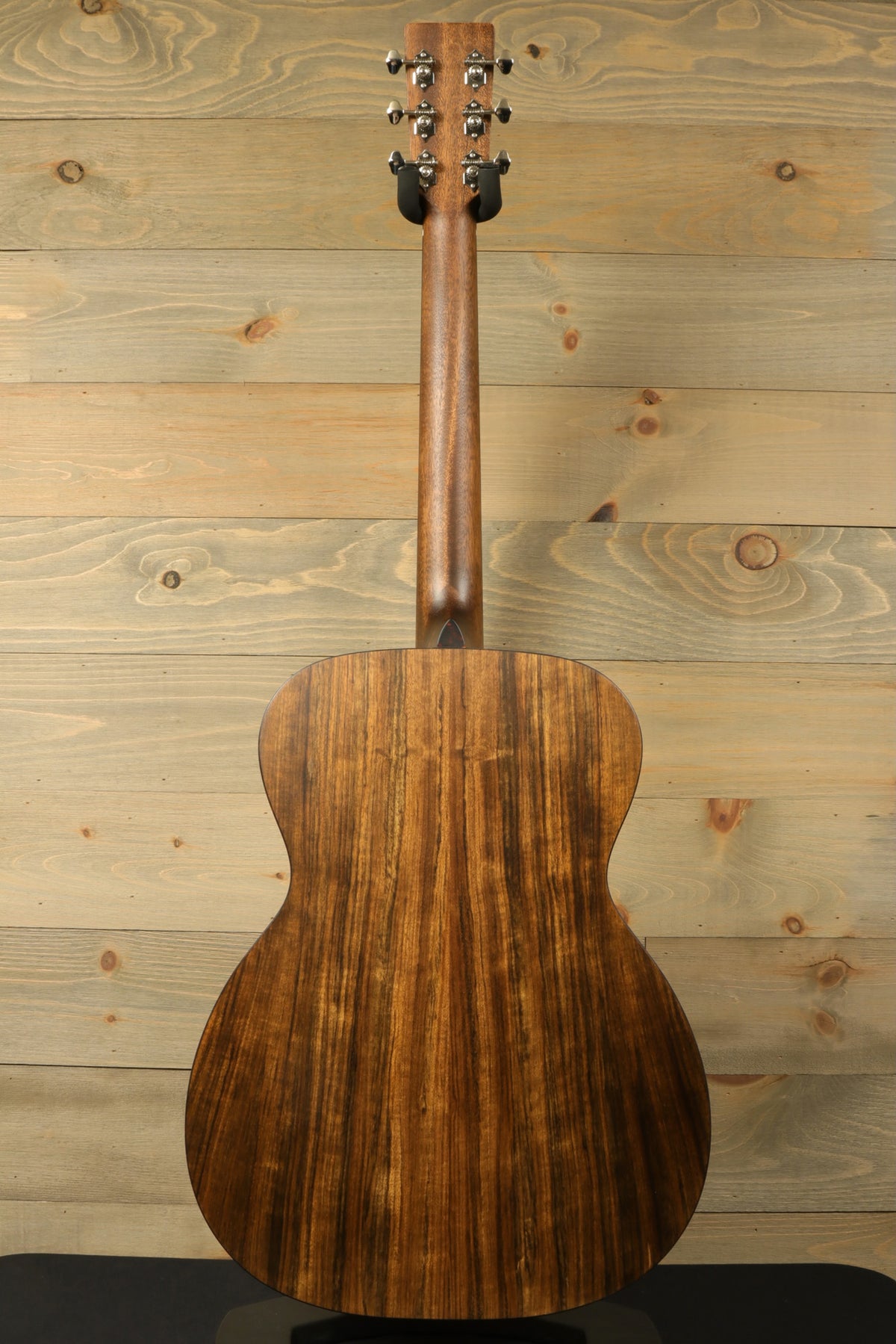 Back view of the Eastman E3OME showcasing the intricate wood grain of the solid ovangkol back and neck with styled headstock.