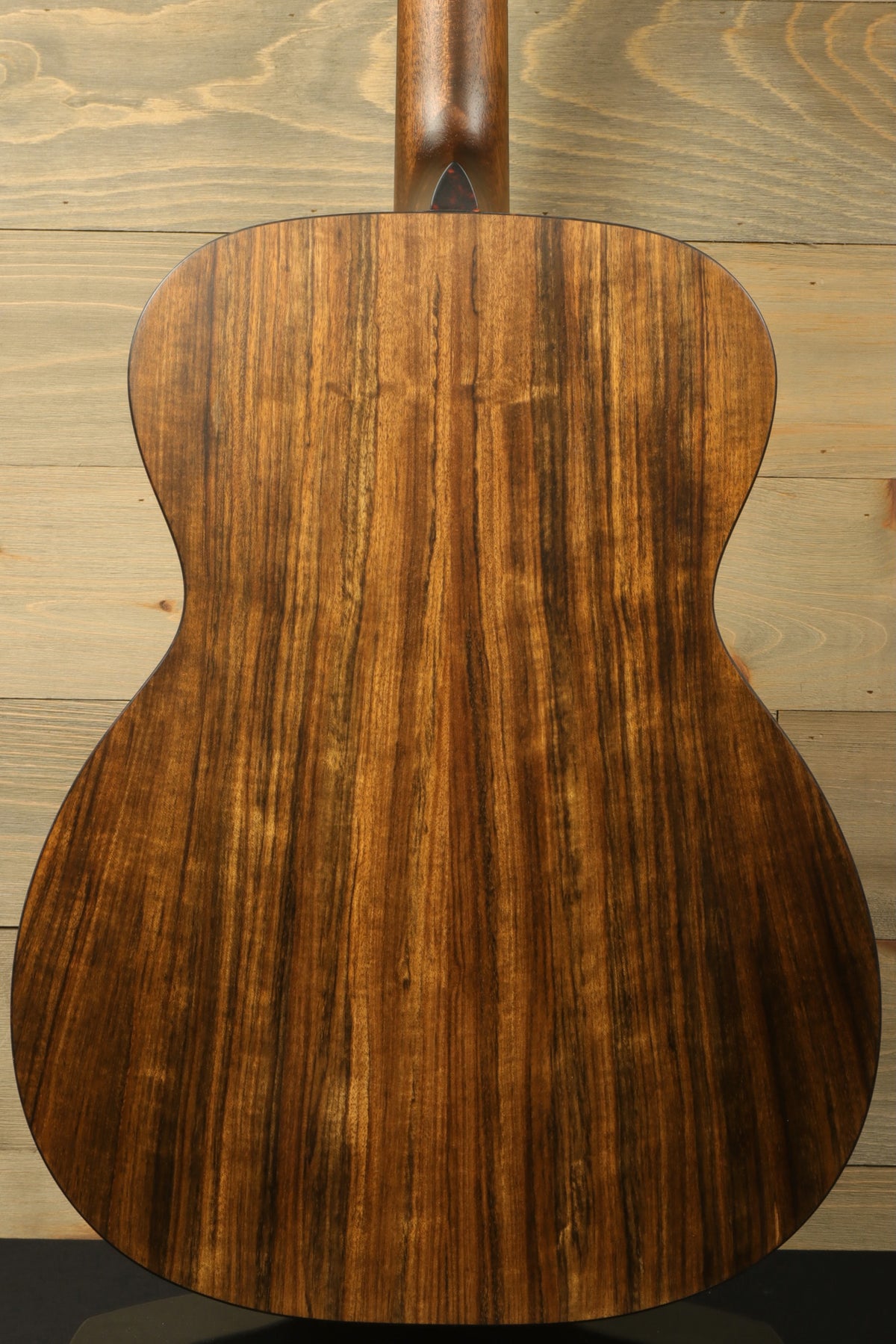 Back view of the Eastman E3OME acoustic guitar highlighting the solid ovangkol back, showcasing its beautiful wood grain and craftsmanship.