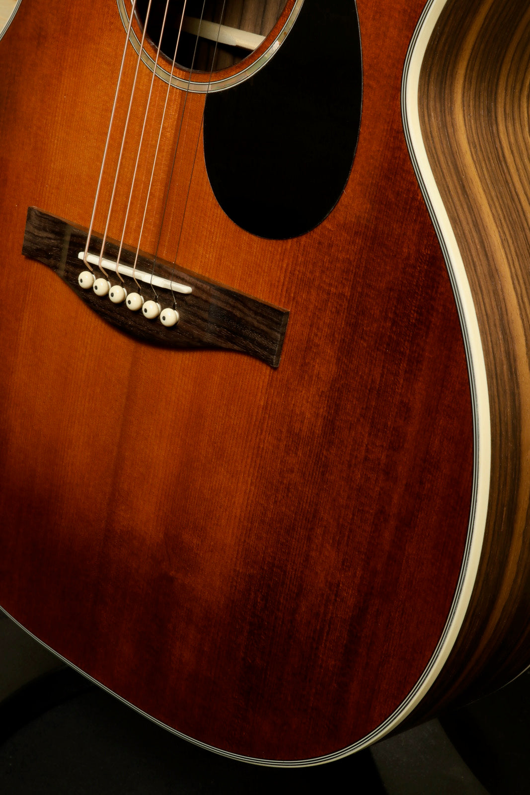 Eastman PCH2-OM-CLA acoustic guitar with a warm brown finish, front view highlighting the body and rosette