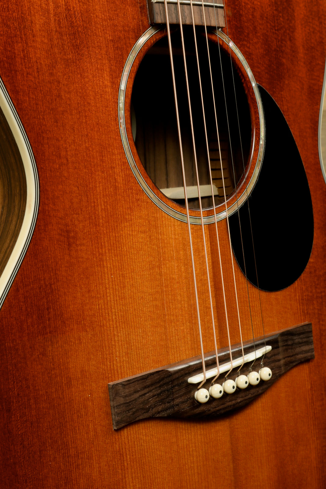 Eastman PCH2-OM-CLA acoustic guitar in a rich sunburst finish, close-up view of the body and soundhole
