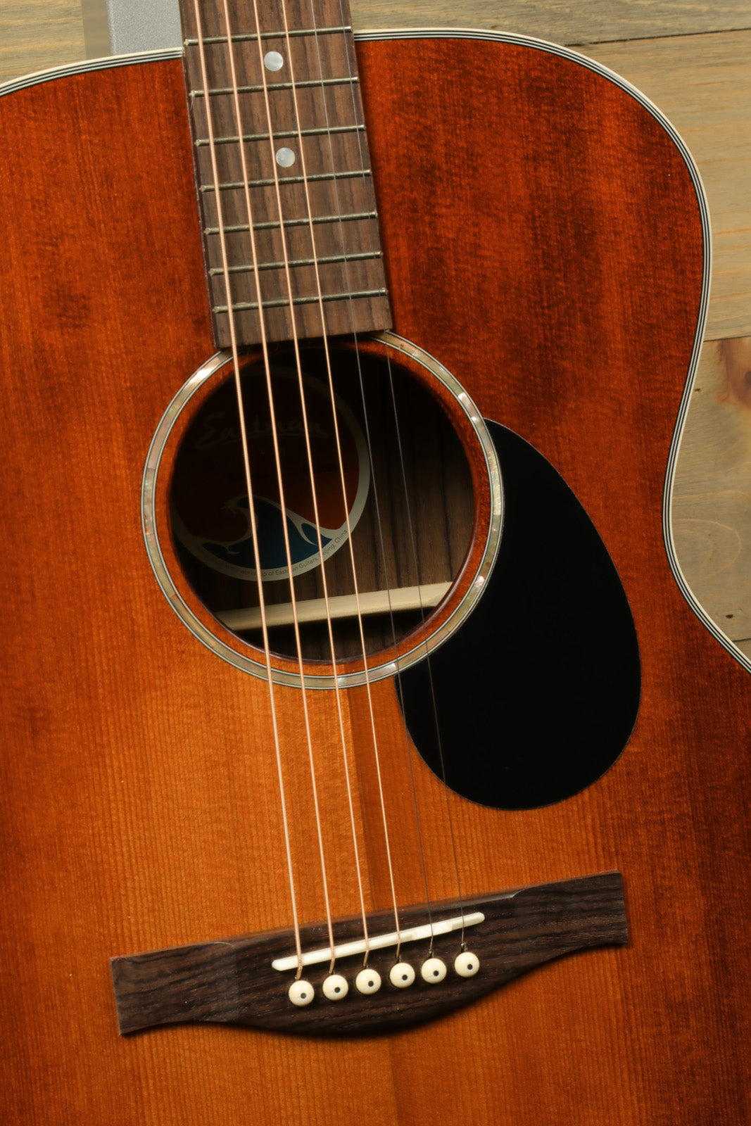 Eastman PCH2-OM-CLA acoustic guitar in sunburst finish, front view showcasing the soundhole and bridge