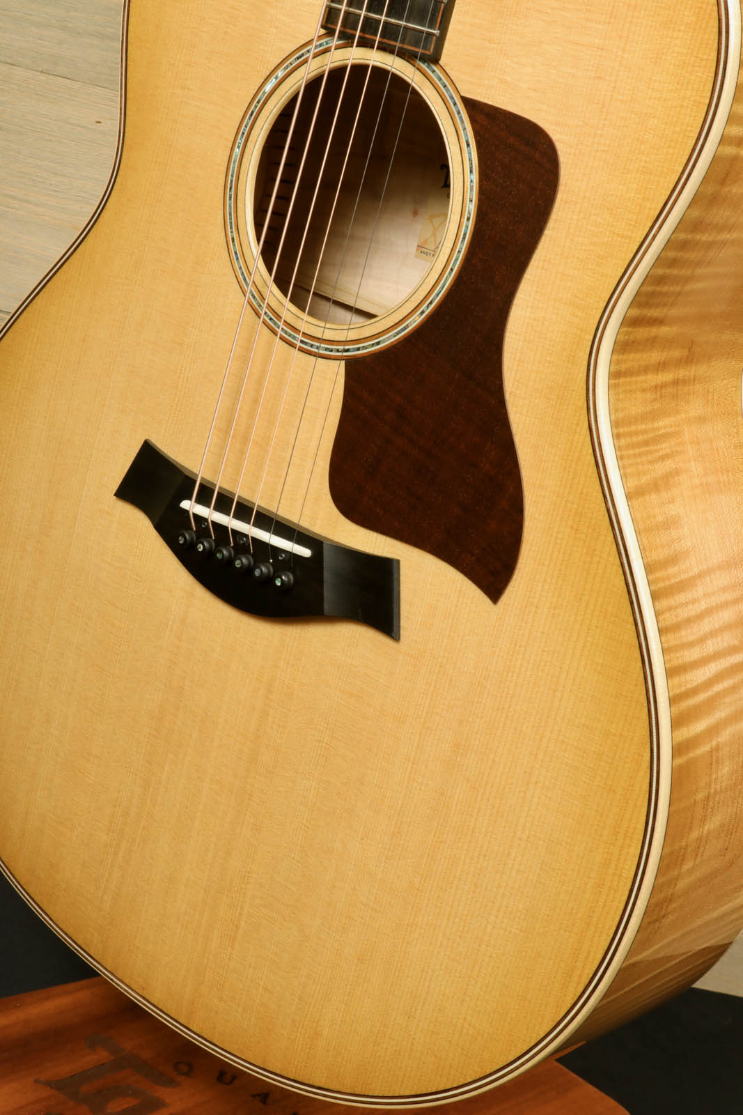 a close up of a guitar on a stand