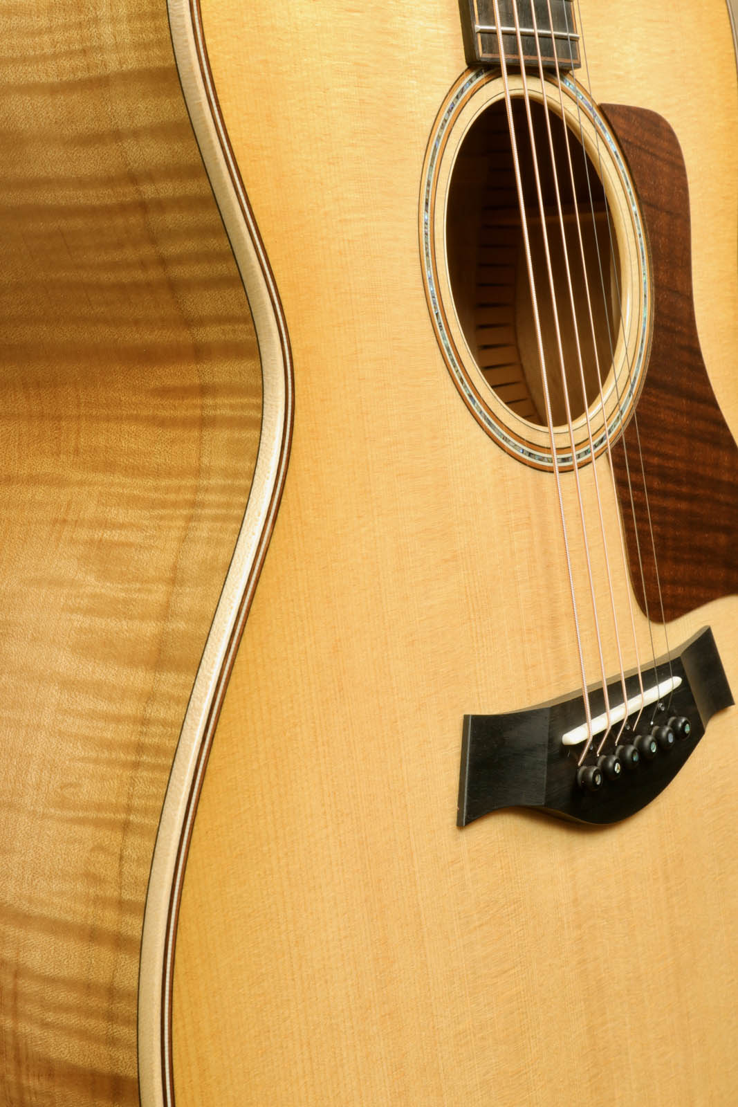 a close up of a guitar with a wooden back and sides