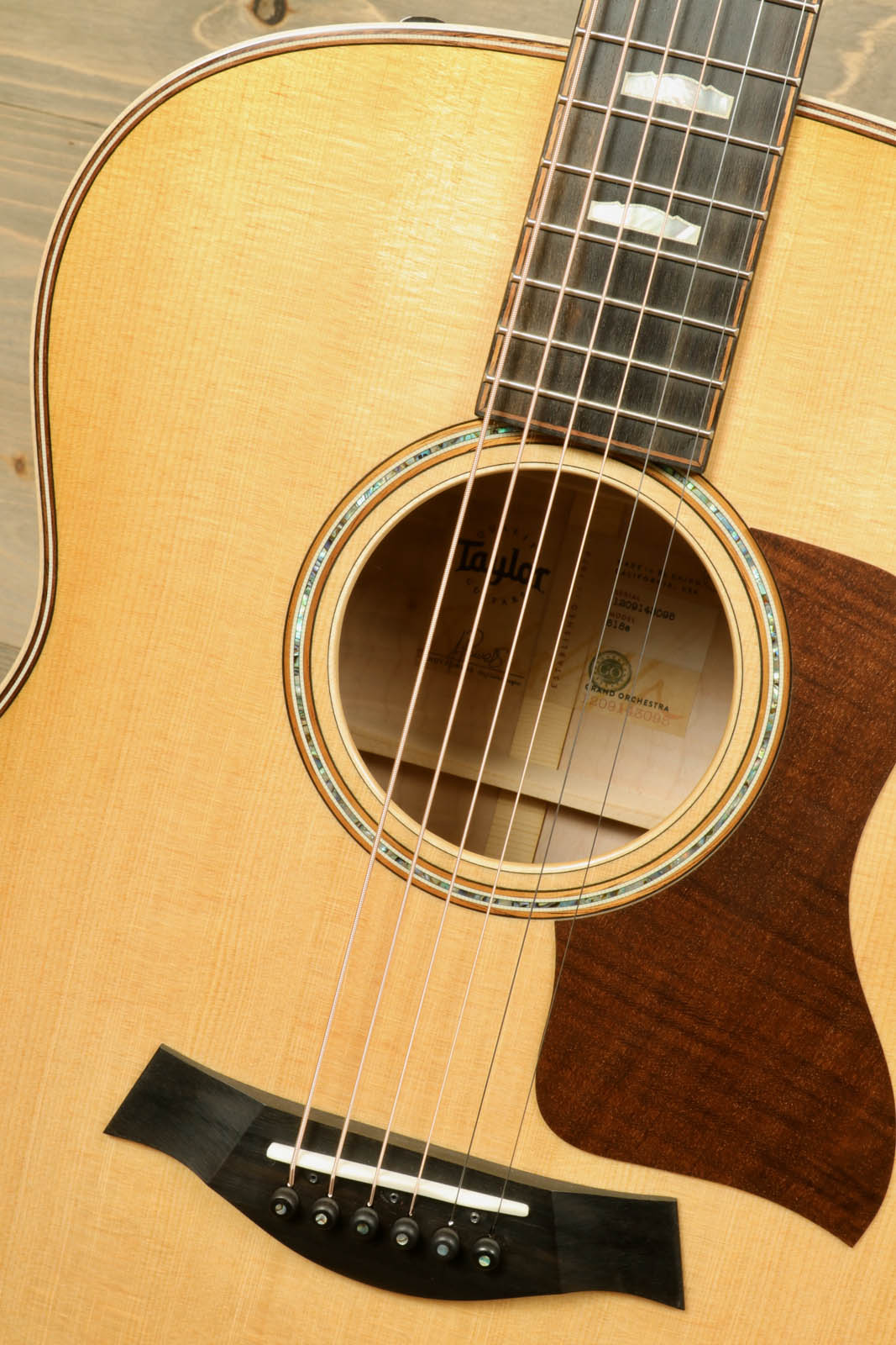 a close up of an acoustic guitar on a table