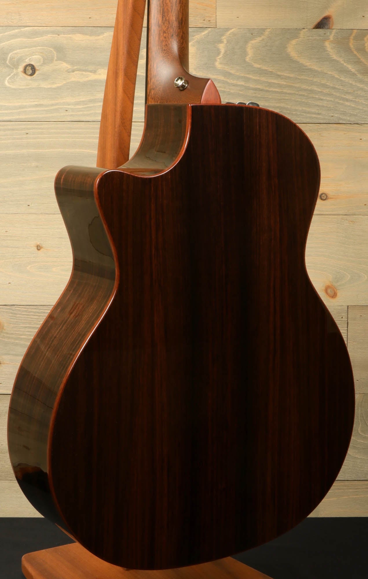 a close up of a guitar on a stand