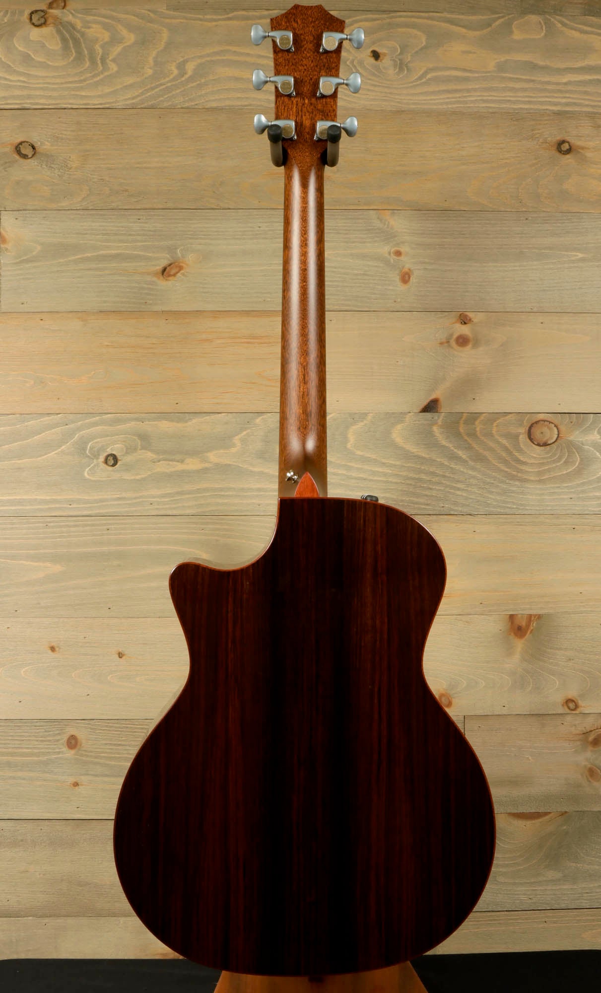 a close up of a guitar on a stand