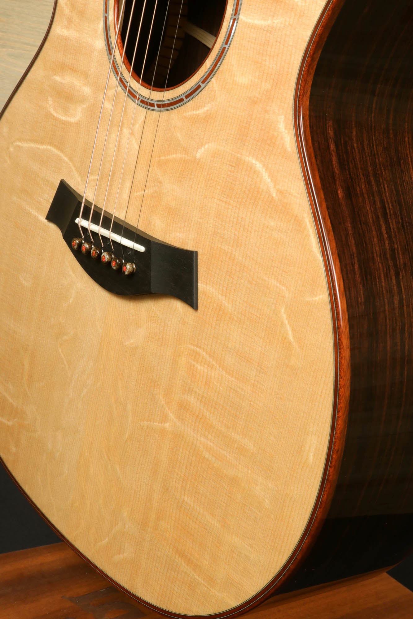 a close up of an acoustic guitar on a table