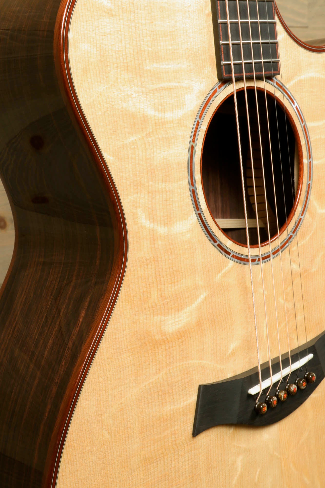 a close up of a guitar with a wooden body