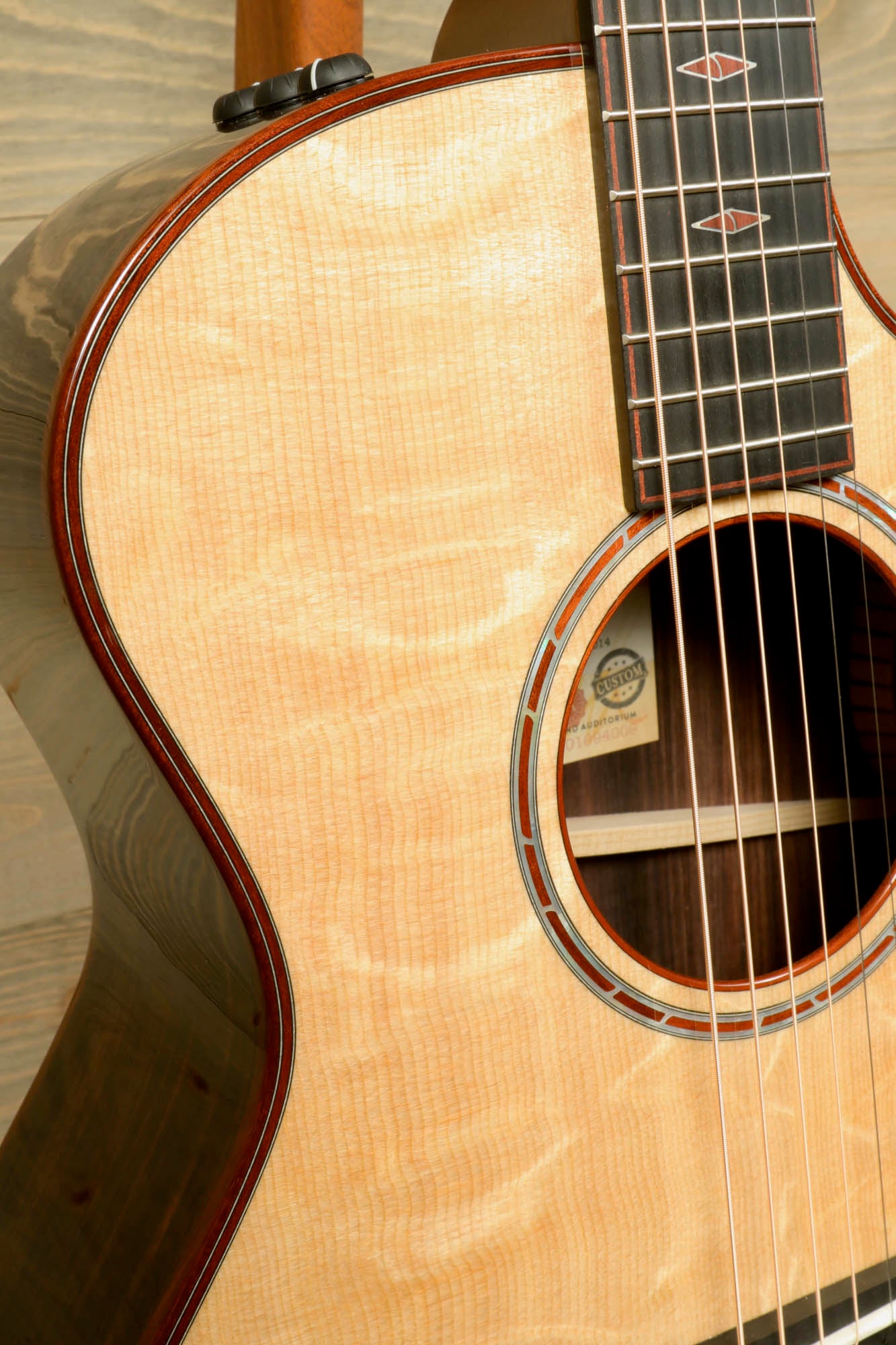 a close up of a guitar with a wooden back and sides