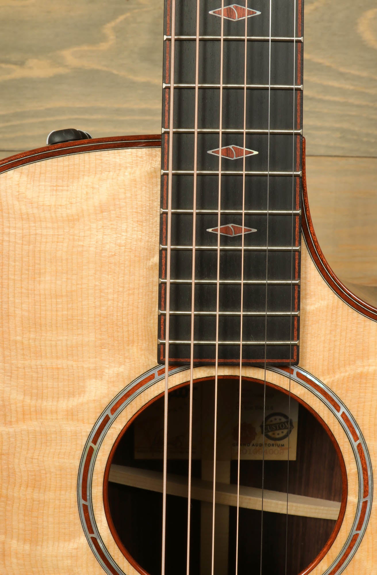 a close up of a guitar with a wooden back and sides