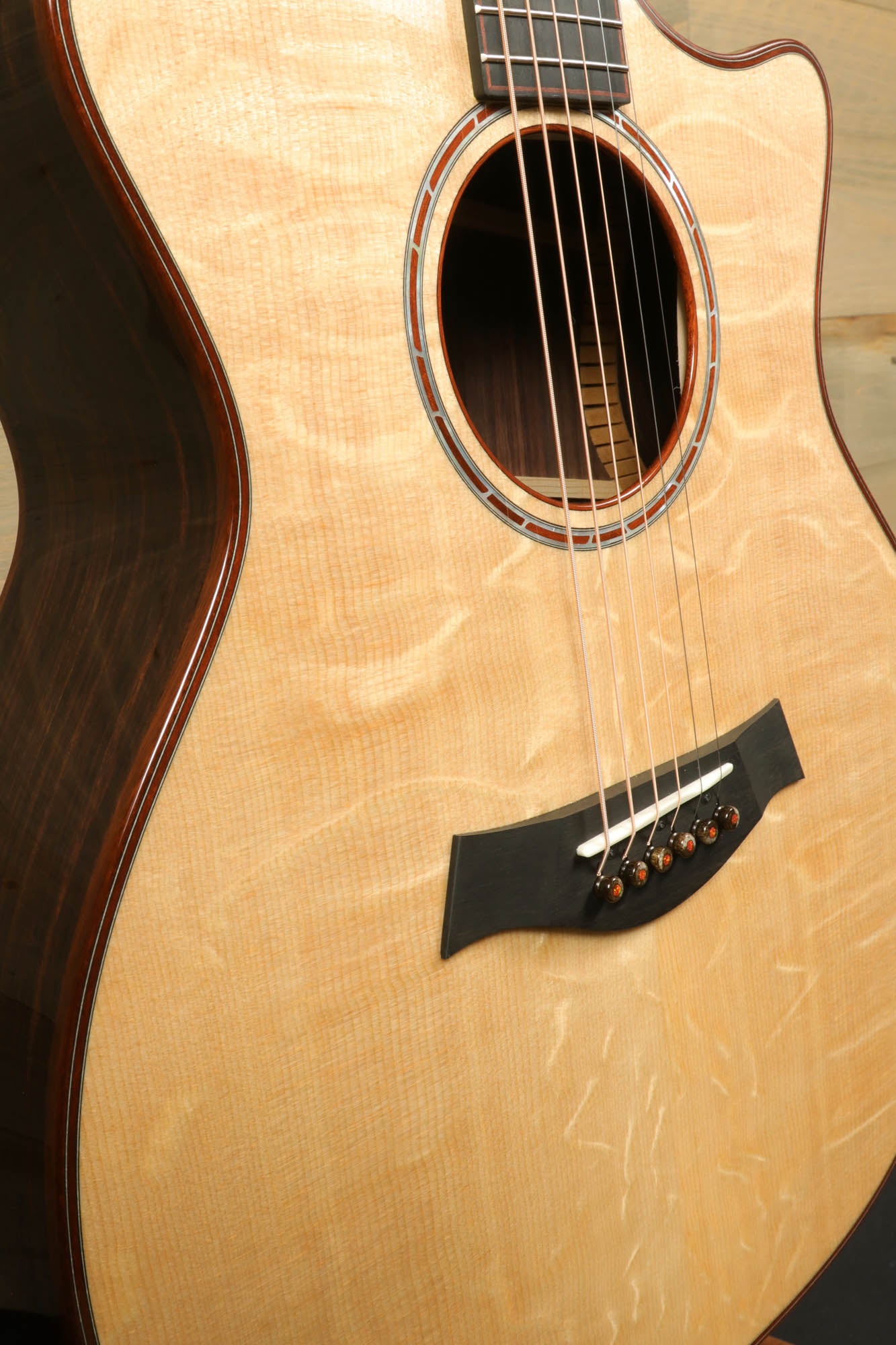 a close up of a guitar with a wooden back and sides