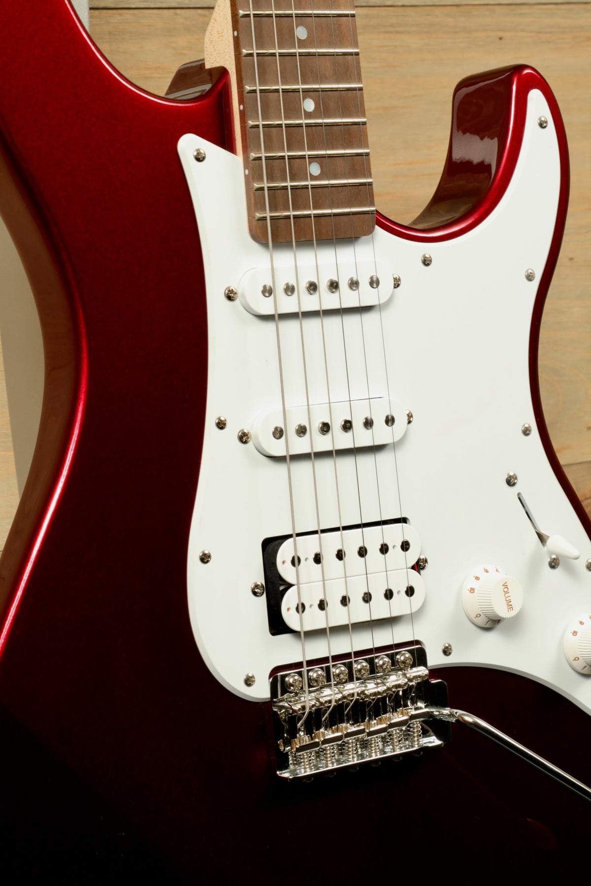 Yamaha PAC012 Pacifica Electric Guitar in metallic red, close-up view of body and pickups