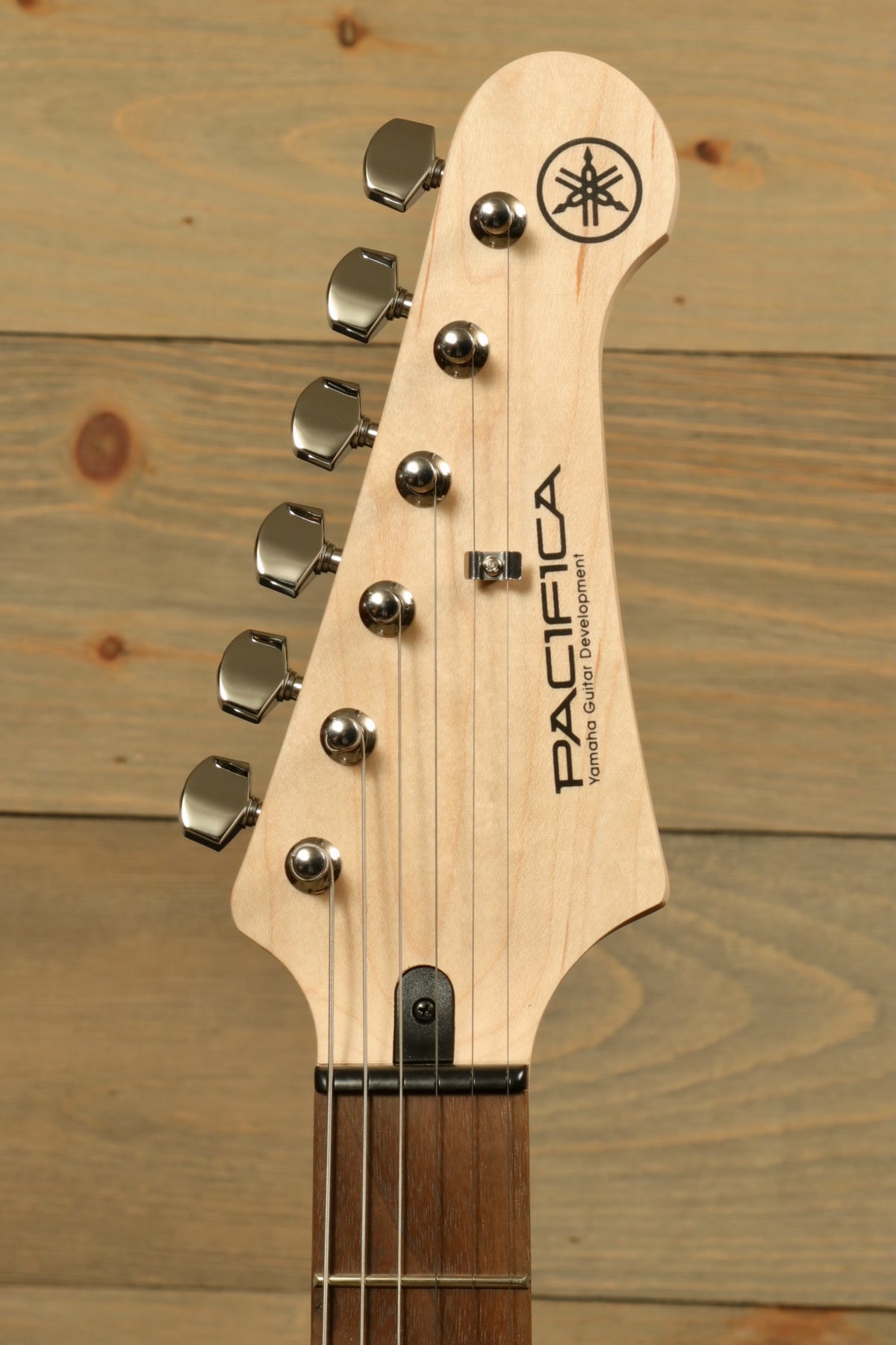 Yamaha PAC012 Pacifica Electric Guitar headstock view with chrome tuning pegs and natural finish