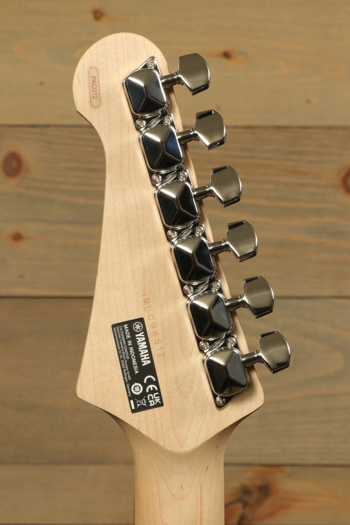 Yamaha PAC012 Pacifica Electric Guitar headstock in natural wood finish, rear view showcasing tuning pegs