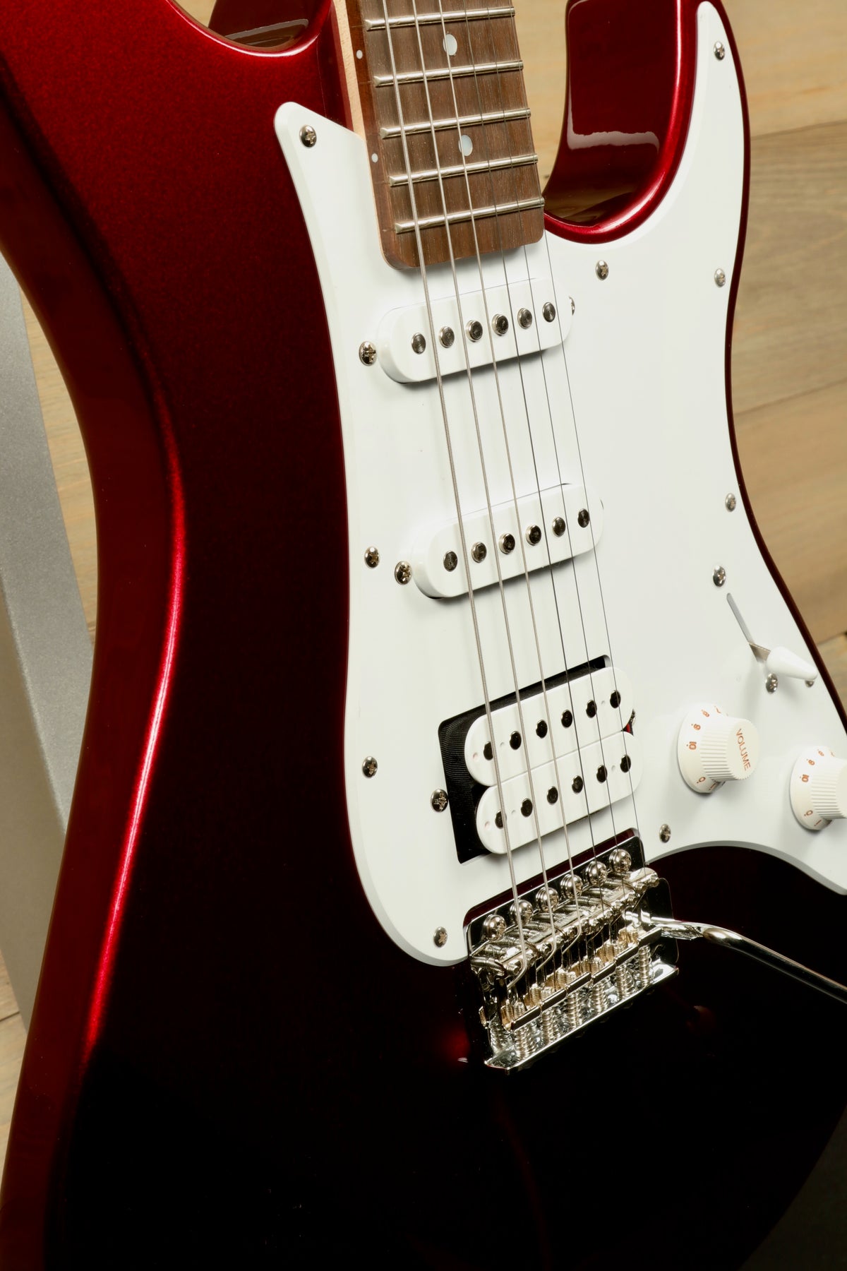 Yamaha PAC012 Pacifica Electric Guitar in glossy red, side view showcasing pickups and bridge