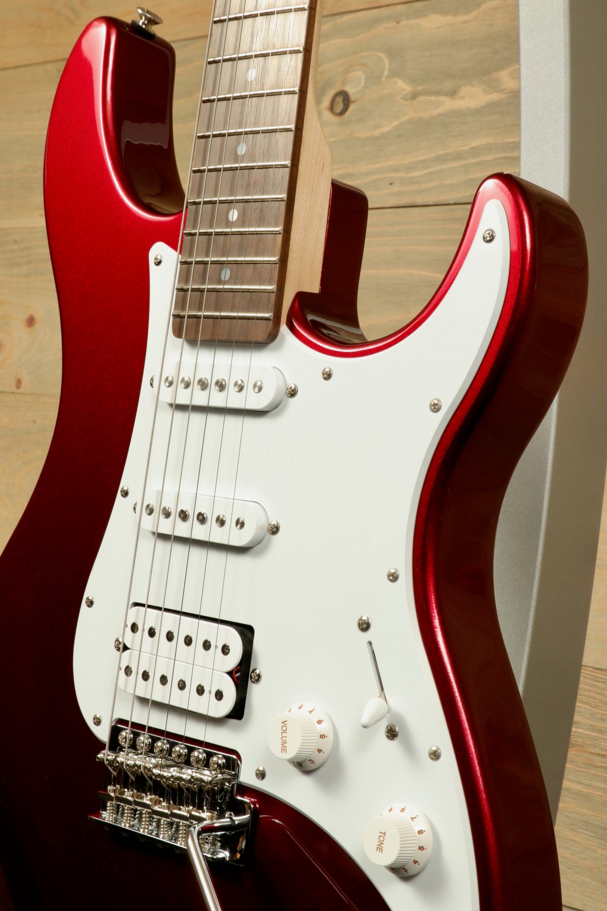 Yamaha PAC012 Pacifica Electric Guitar in red metallic, side view showcasing the body and pickups