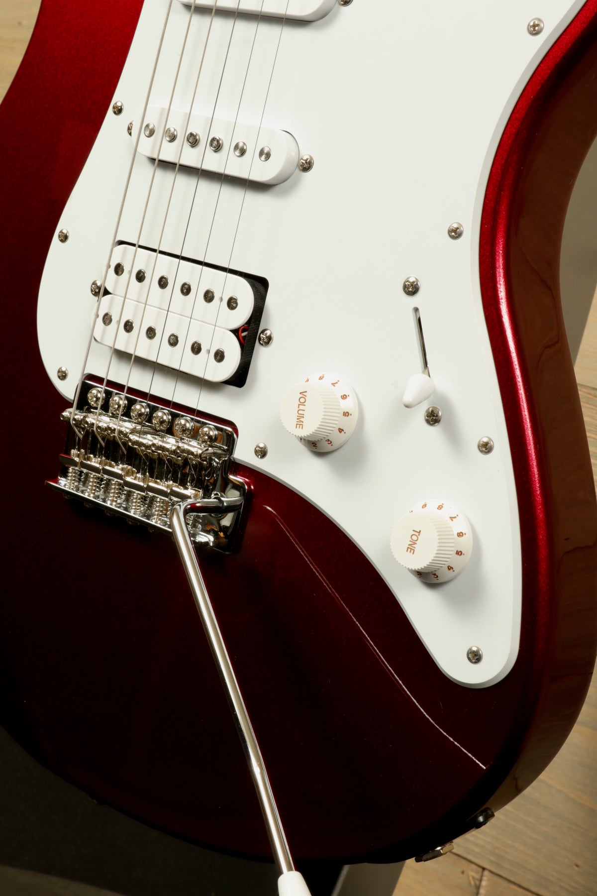 Yamaha PAC012 Pacifica Electric Guitar in red with white pickguard, close-up view of controls and tremolo